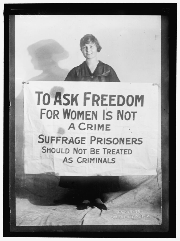 Lucy Branham holding a poster that says 