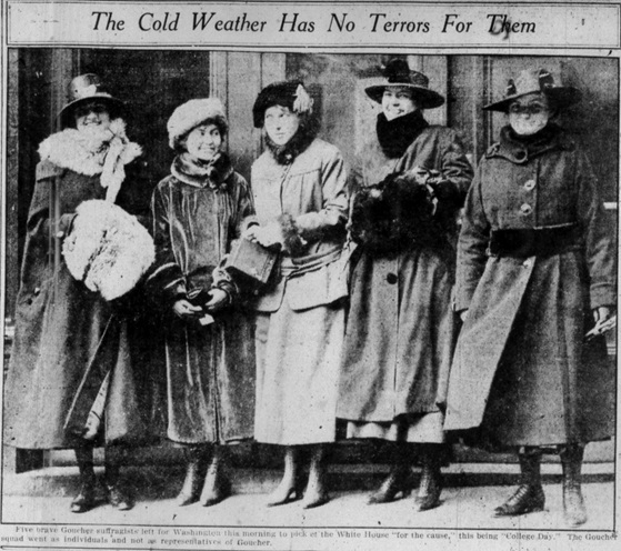 five women smiling, dressed in hats and coats