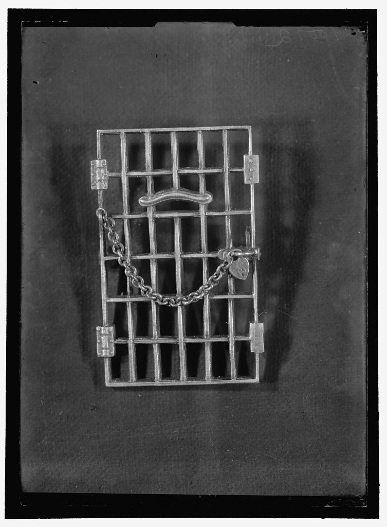 Rectangular jail cell door pin with a chain and heart
