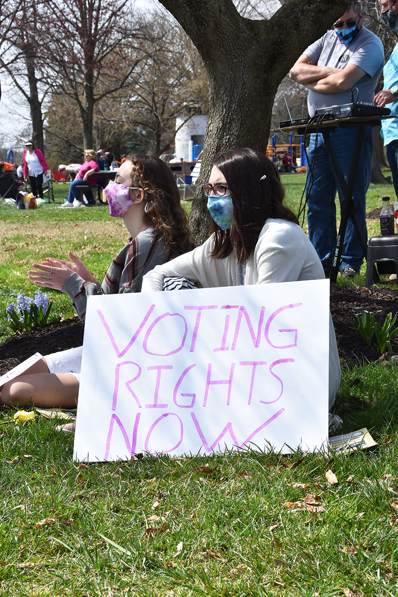 Young girls with a sign that says "Voting Rights Now"