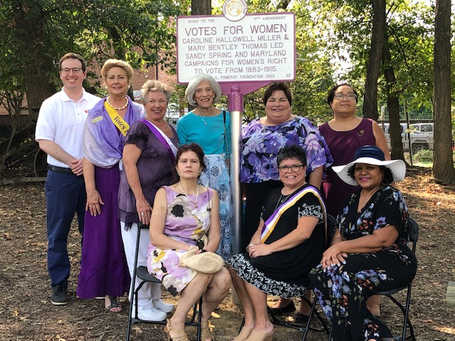 MWHC Board members and volunteers, with Steve Bodnar, William G. Pomeroy Foundation. Front: Christine Valeriann, Amy Rosenkrans, Kalin Thomas. Back: Steve Bodnar, Kate Campbell Stvenson, Diana Bailey, Pam Young, Maria Darby, Jean Thompson standing with the historical marker