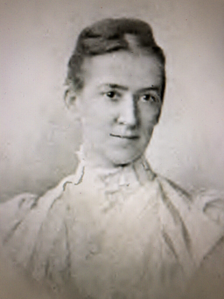 Portrait of Florence Trail, circa early 20s, wearing high neck lace dress