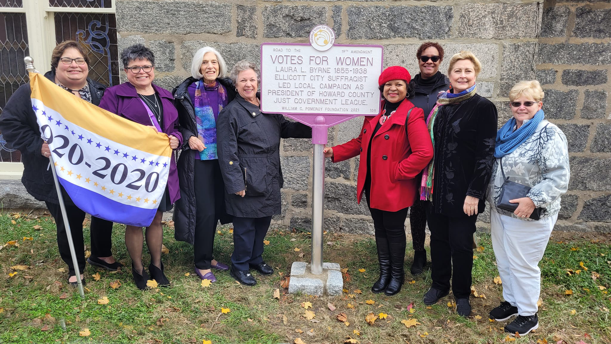 eight women standing around a historical marker dedicated to Laura L. Byrne