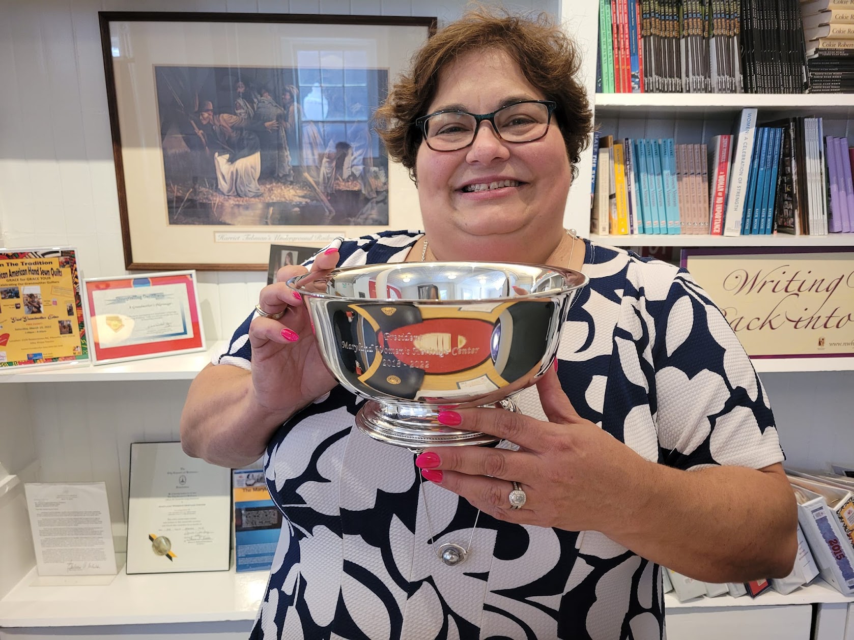 Maria Darby holding a silver bowl
