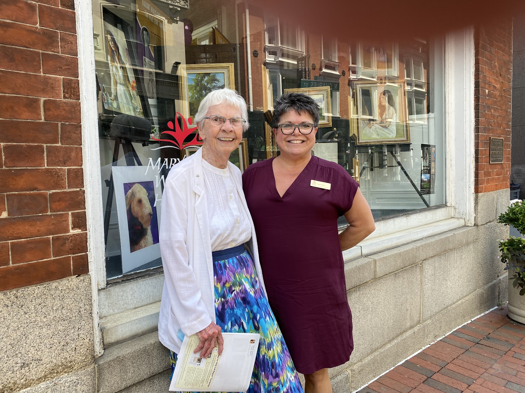 Sister Kathleen Feeley, SSND with MWHC Board Member Amy Rosenkrans, exterior of building