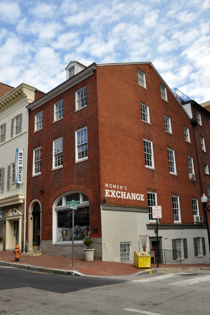 Brick 3 story building on Charles and Pleasant in Baltimore, the name Woman's Exchange is painted on side