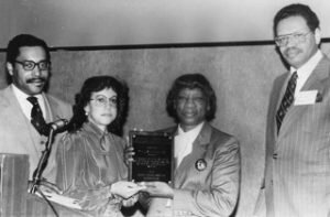 Professor Phyllis Ann Wallace (second right) receives the Westerfield Award, for black economists with outstanding achievements, from the National Economic Association, on February 8, 1982. (L to R:) Dr. Bernard Anderson (NEA President), Dr. Margaret Simms (Chair), Dr. Alfred Osborne (former NEA President).  Photograph courtesy of MIT Museum.<br />
