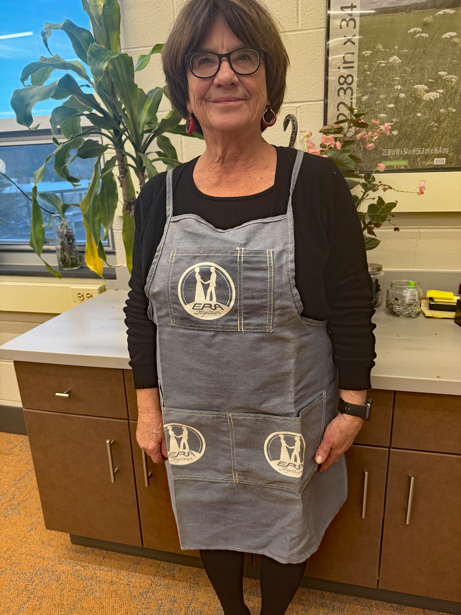 Author Cherie Smith is wearing an ERA apron given to her by Bernice Friedland 