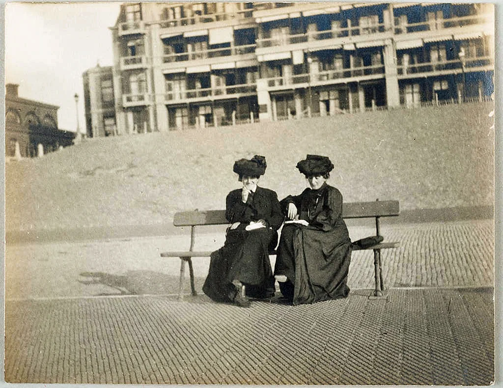 The Cone sisters on the beach at Scheveningen, Holland, circa August 27 - 30, 1903. Both dressed in long black dresses and hats. Claribel and Etta Cone Papers, Archives and Manuscript Collections, The Baltimore Museum of Art. CG.11