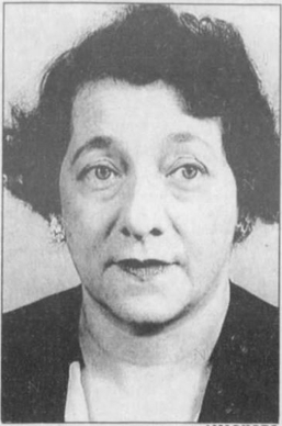 A White middle aged headshot of Rose Zetzer. She has a bob hair cut and wearing a black blouse.