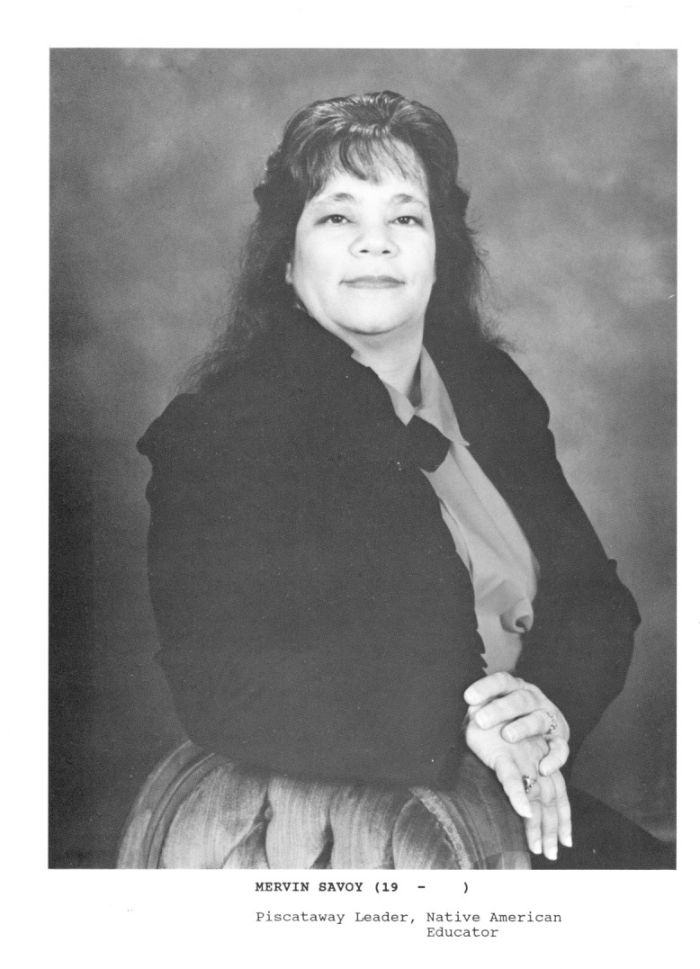 A Black and white portrait of Ms Savoy, aged about 40. Sitting looking at camera and wearing a black jacket