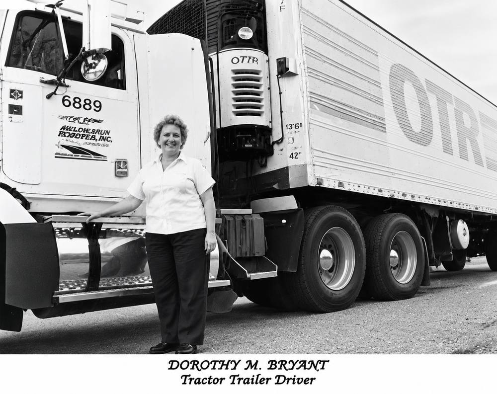 Dorothy Bryant, aged about 40s standing in front of a tractor trailer, smiling