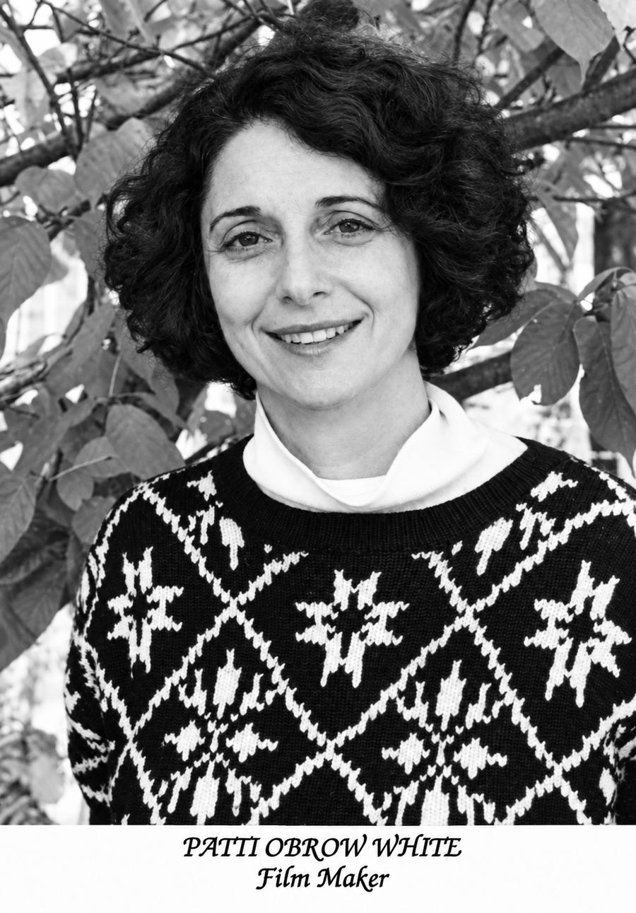 B & W headshot of White, turtleneck with pattered sweater